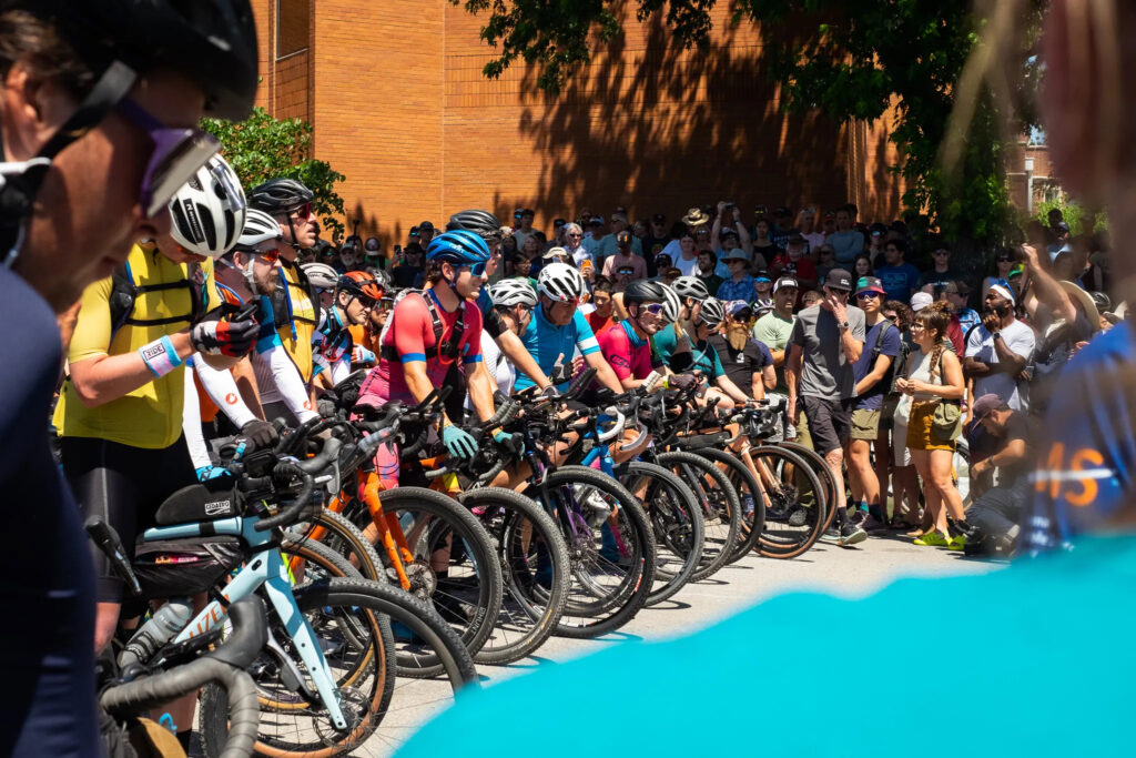 A large group of riders stands at the start line of the Unbound XL ride in 2022. 