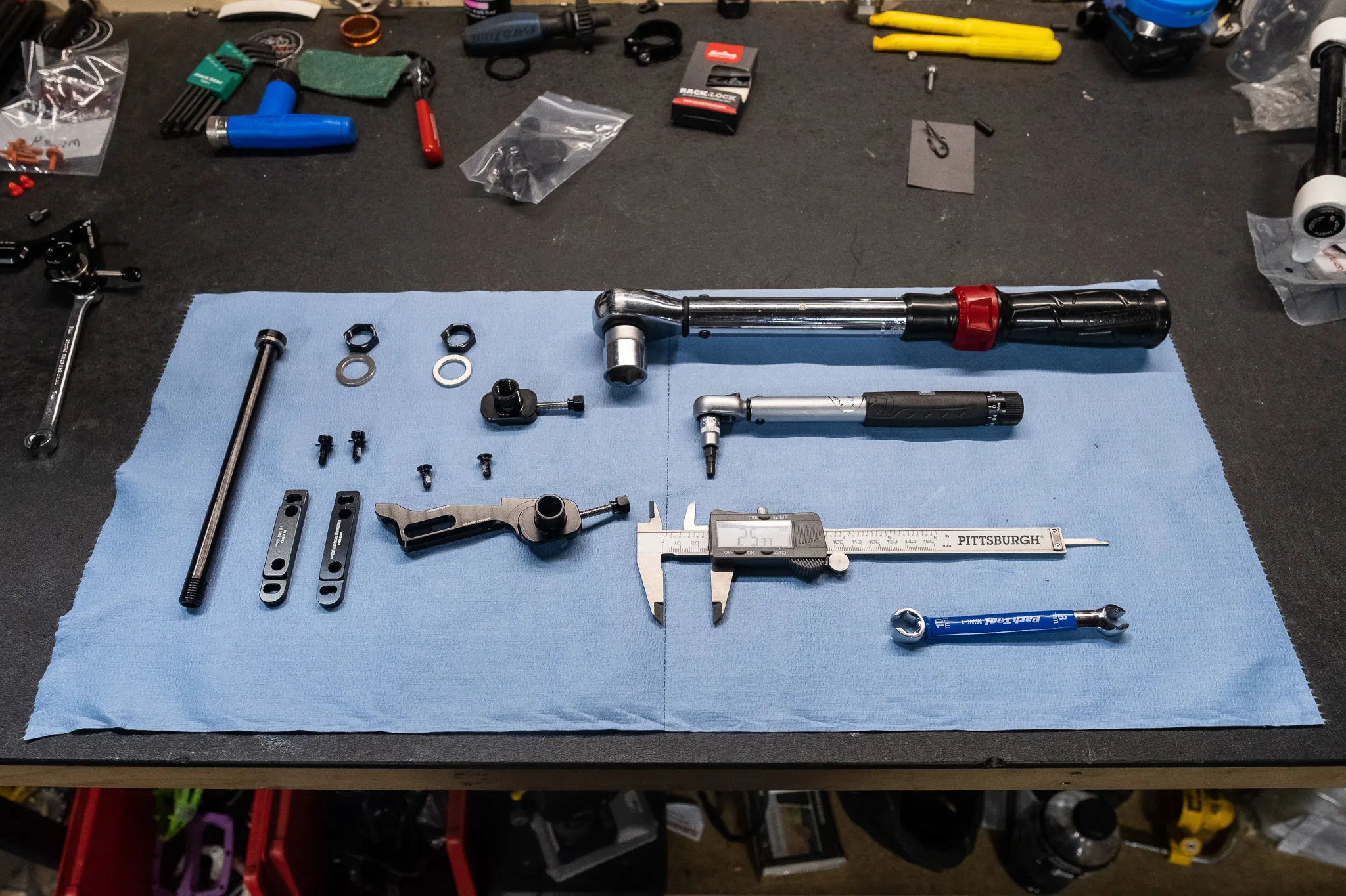 A workshop table showing the tools needed to install the Otso Cycles Single Speed Tuning Chip Conversion Kit on an Otso Cycles Warakin Stainless or Warakin Ti bicycle.